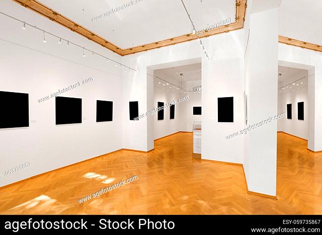empty gallery room or showroom with blank picture frames, exhibition mock-up