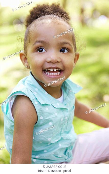 Mixed race girl smiling in park
