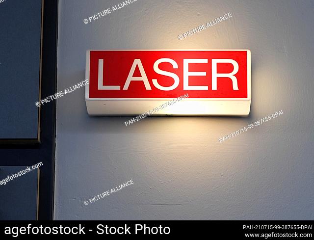 13 July 2021, Thuringia, Jena: An illuminated display with the lettering ""Laser"" can be seen at the Fraunhofer Institute for Applied Optics and Precision...