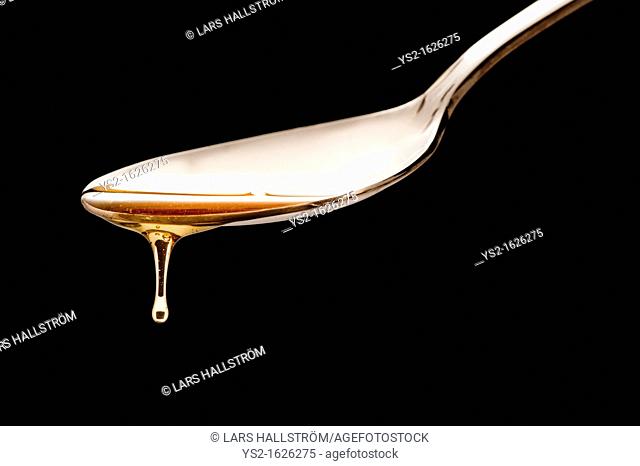 Spoon with dripping honey