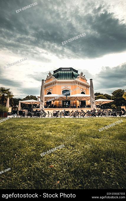Schoenbrunn zoo imperial pavilion cafe on a sunny crowded day among green bushes in vienna austria
