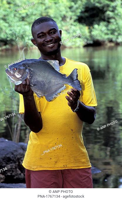 'Bosneger' with his catch in the Central Surinam Nature Reserve  Surinam  South America