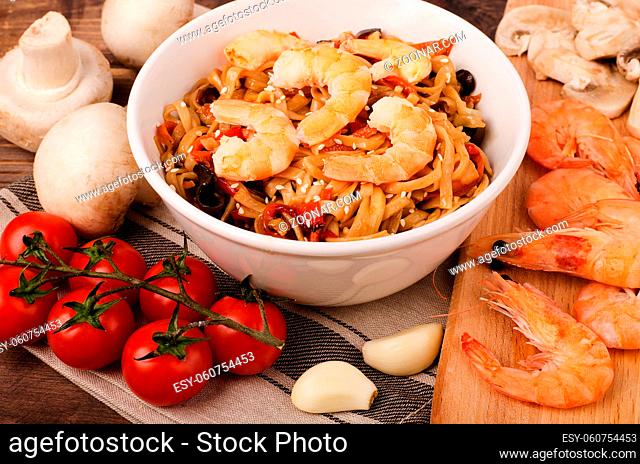Chinese noodles with shrimp and vegetables in soy sauce, with other ingredients