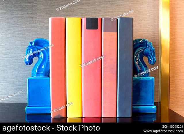 elegant book ends and books on table in modern study