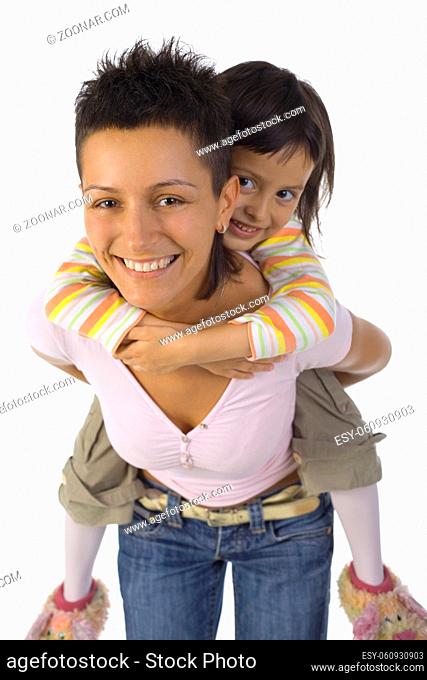 Smiling mother with daughter on back. Isolated on white in studio. Looking at camera