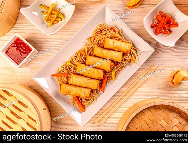 Flat lay of fresh fried Chinese traditional spring rolls food with pasta
