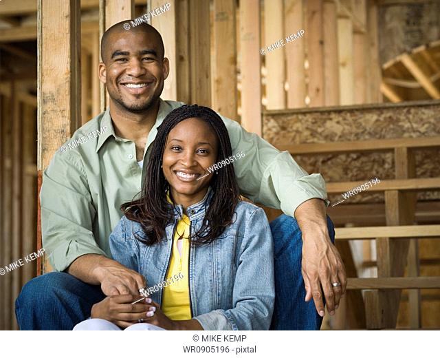Portrait of a young couple sitting and smiling