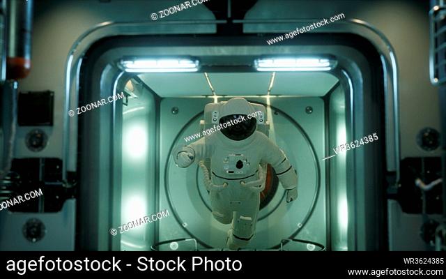 astronaut inside the orbital space station