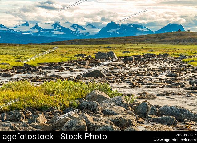 Landscape with creek and mountains of Sarek national park in background with storm comming in, along the kings trail, Swedish Lapland, Sweden