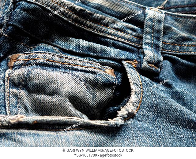 close up detail of blue denim jeans trousers pants