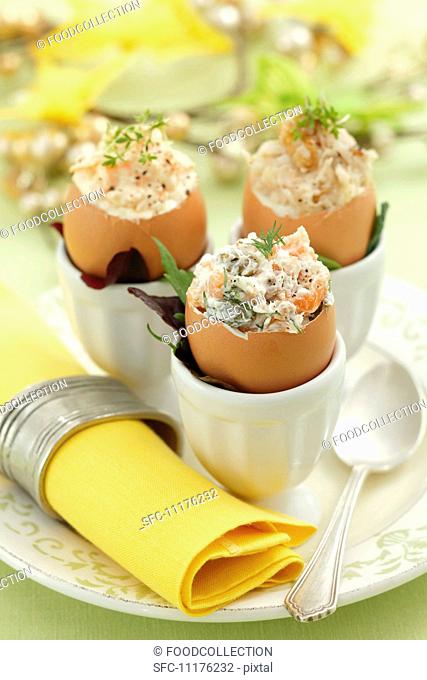 Assorted filled eggshells: with celery and walnuts, with carrots and horseradish, and with salmon