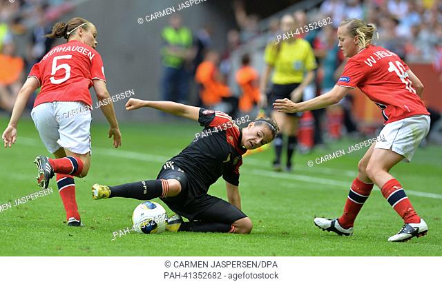Lena Lotzen (C) of Germany fights for the ball with Toril Hetland Akerhaugen (L) and Kristine Hegland of Norway during the UEFA Women«s EURO 2013 final soccer...