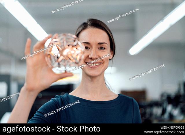 Happy female design professional holding 3D drone in industry