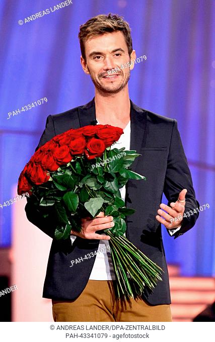 Show host Florian Silbereisen holds a bouquet of roses during the TV music show 'Herbstfest der Traeume' ('Autumn Festival of Dreams') in Erfurt, Germany