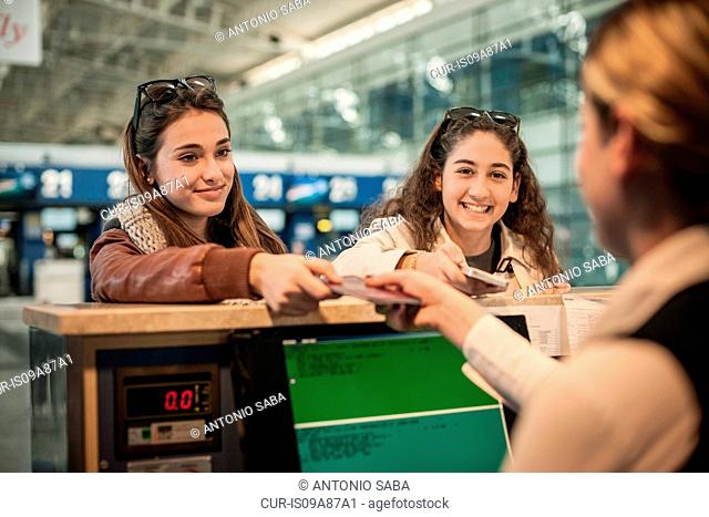 Two teenage girls at airport check in area