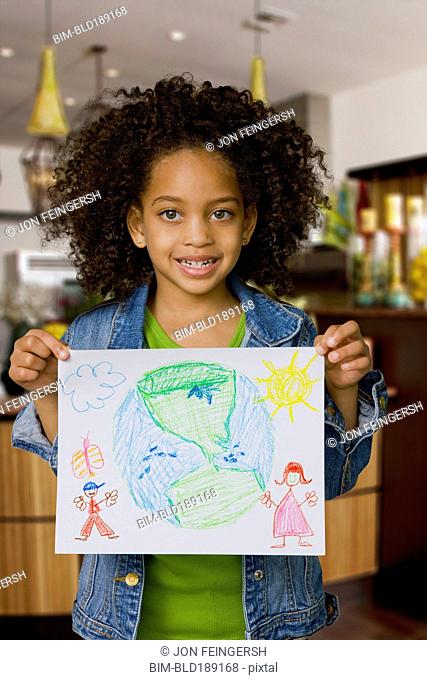 African girl holding drawing of the Earth