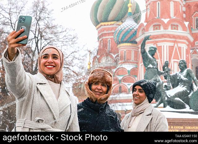 RUSSIA, MOSCOW - DECEMBER 3, 2023: People take a selfie by St Basil's Cathedral in Red Square during a snowfall. Vyacheslav Prokofyev/TASS
