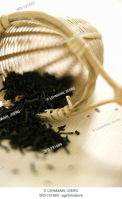 Dry green jasmine tea in bamboo tea strainer