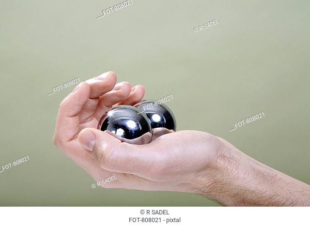 A human hand holding Chinese medicine balls