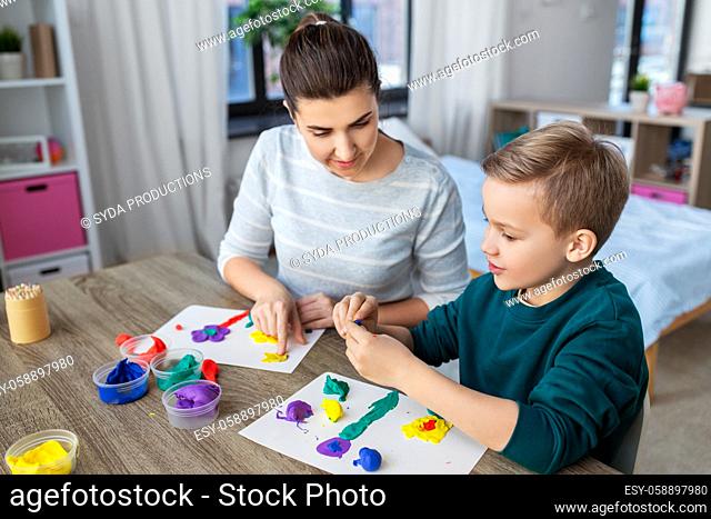 mother and son playing with modeling clay at home