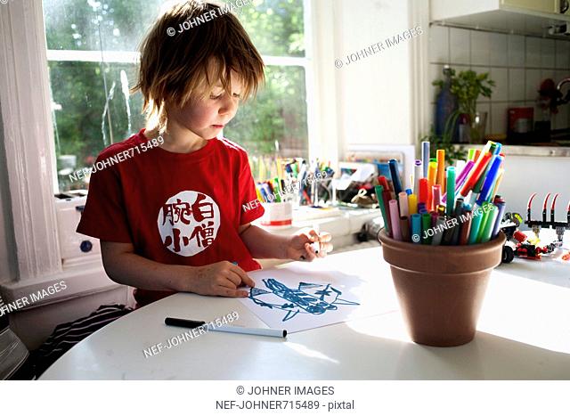 A boy at home drawing, Sweden
