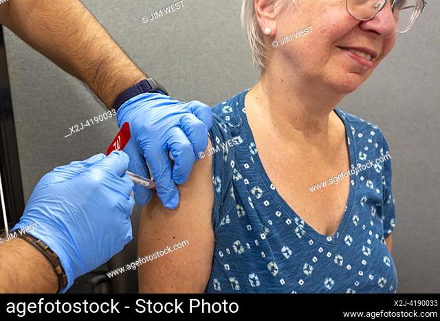 Detroit, Michigan USA - 18 September 2023 - Susan Newell, 74, gets one of the first updated covid immunizations given at a local Walgreens pharmacy