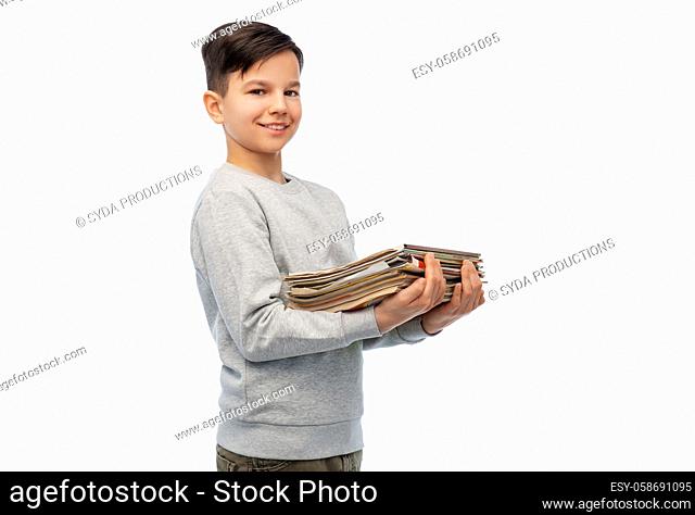 smiling boy with magazines sorting paper waste