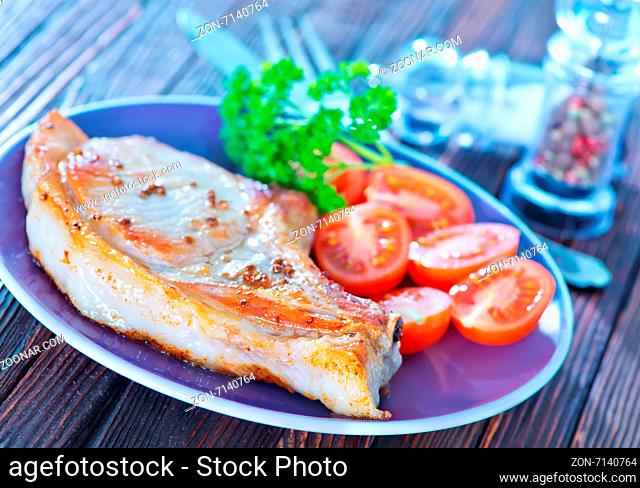 fried steak with tomato on the plate