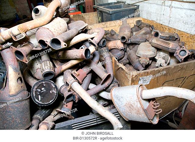 Pile of old catalytic converters at a metal recycling centre