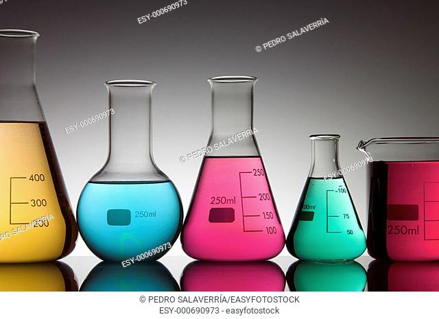 five flasks with bright colored liquid