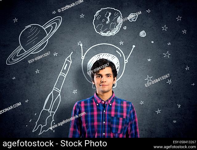 Student guy in jacket and glasses dreaming to become astronaut