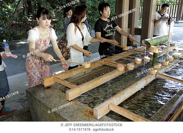 Japan, Tokyo, Shibuya-ku, Meiji Jingu Shinto Shrine, temizuya, font, washing, water, hands, feet, mouth, dipper, Asian, woman, man