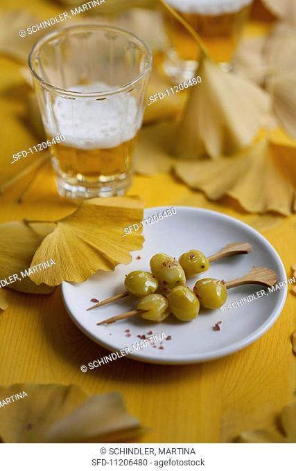 Gingko nuts on skewers and a glass of beer