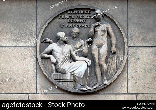 Agnodice, female doctor in front of the Areopagus. Stone relief at the building of the Faculte de Medicine Paris, France