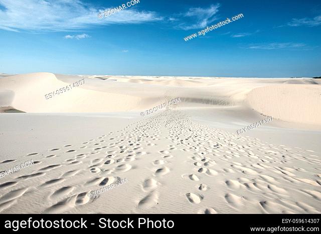 Traces of tourists leading through the sand dunes with blue and green lagoons in Lencois Maranhenses National Park, Brazil