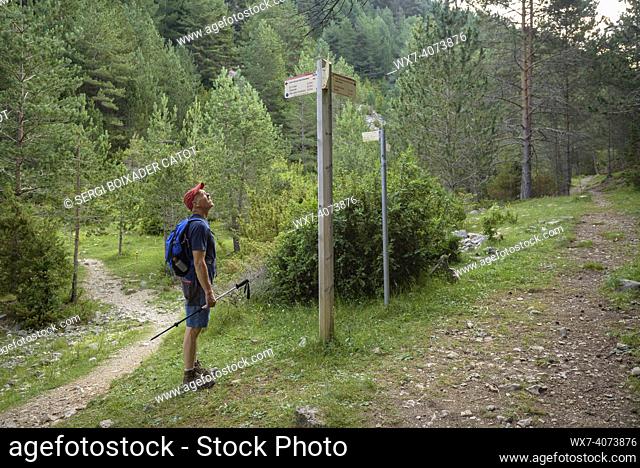 Hiker at a trail junction in Coma de Caners, in the Pedraforca massif (BerguedÃ , Catalonia, Spain, Pyrenees). ESP: Senderista en el cruce de senderos en la...