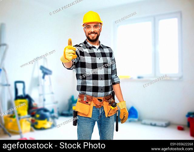 happy male worker or builder showing thumbs up