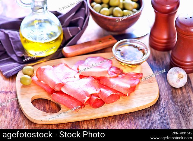 smoked meat on the wooden board and on a table