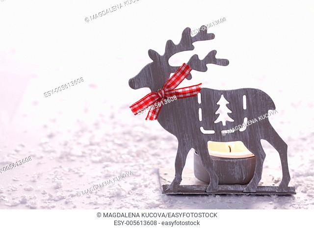 Christmas candlestick on white snowy background