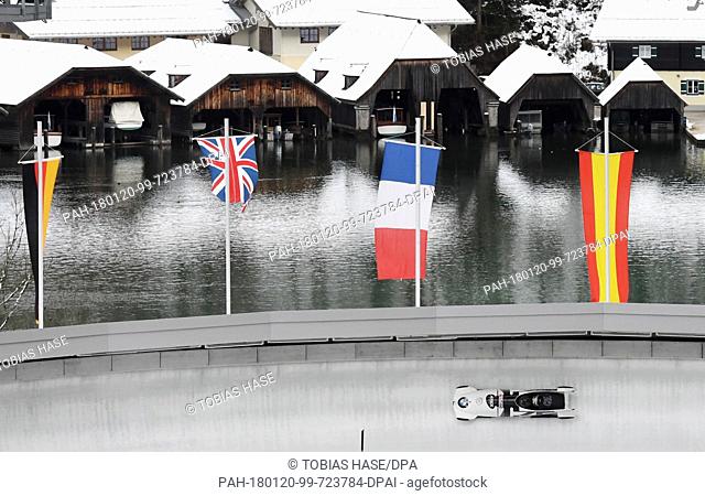 A bobsleigh team on echo-curve, with the boathouses on Koenigssee lake in the background, during the 2-man event at the Bobsleigh World Cup in Schoenau am...