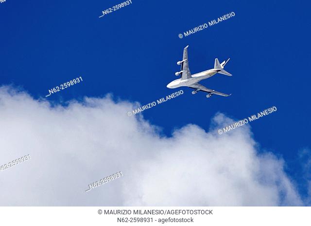 An airplane, airbus, flying in the sky-blue, to the clouds