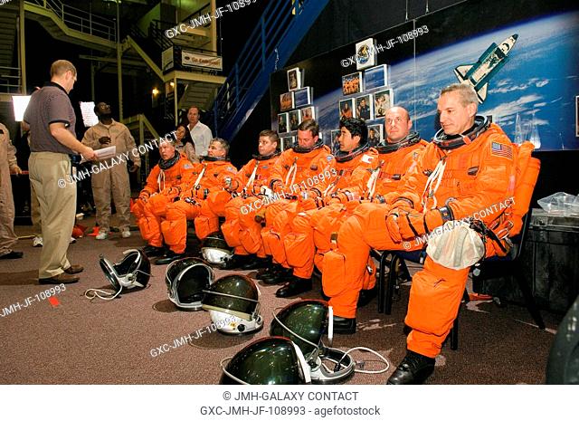 Crew trainer Bob Behrendsen (standing) briefs astronauts Dominic L. Gorie (seated, left), STS-123 commander; Gregory H. Johnson, pilot; Robert L