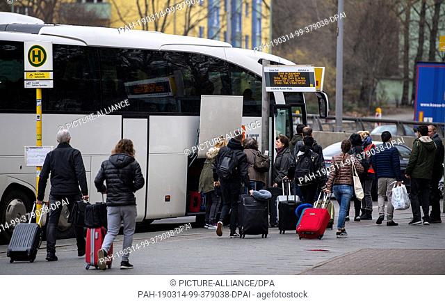 14 March 2019, Berlin: Passengers with luggage board a shuttle bus at Jakob-Kaiser-Platz underground station to travel to Tegel airport