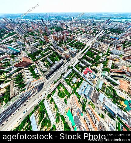 Aerial city view with crossroads and roads, houses, buildings, parks and parking lots, bridges. Helicopter drone shot. Wide Panoramic image