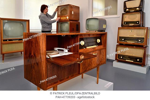 Old radios and TVs from the GDR (German Democratic Republic) with the radio-phonograph 'Petra A' from 1966 in the foreground in the exhibition '5 out of 35'...