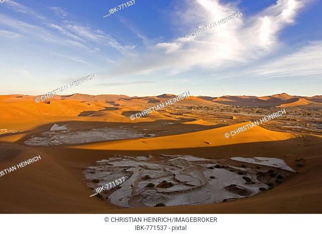 View from a sand dune upon dried up clay pans and dune landscape in Deadvlei, Namib Desert, Namibia, Africa