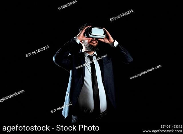 Businessman Wearing Suit Gesturing And Wearing Virtual Reality Simulator