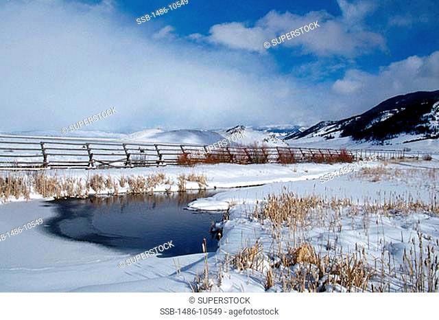 Fence on a snow covered landscape, National Elk Refuge, Wyoming, USA