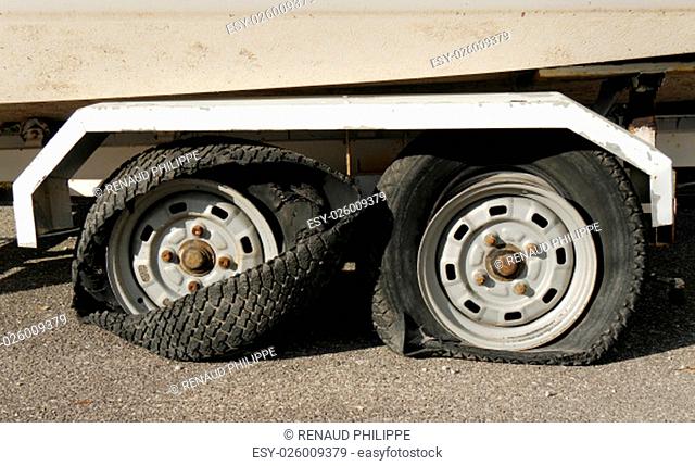 two tires totally destroyed on a trailer