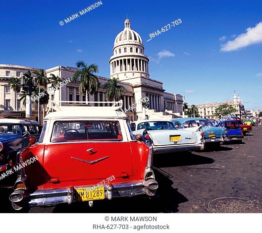 Street scene of taxis parked near the Capitolio Building in Central Havana, Cuba, West Indies